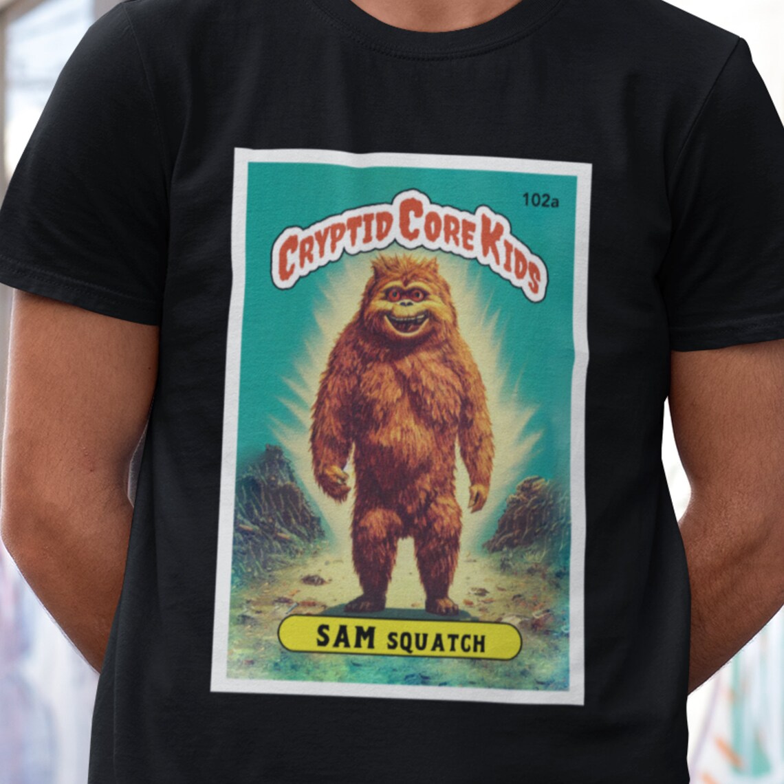 Sam Squatch Bigfoot T-Shirt | Sasquatch Teeshirt | Cryptid Core Kids Tee Shirt | Cryptidcore Gift Cryptozoology | GPK Parody Garbage Pail